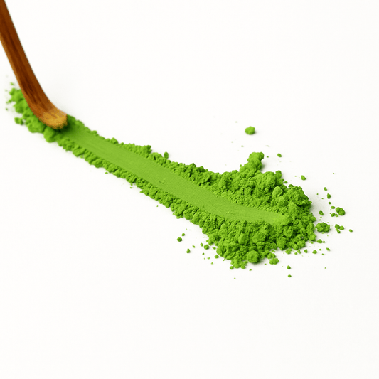 ZENERGY TEA Matcha Powder in vibrant green, served with a bamboo whisk for tea preparation