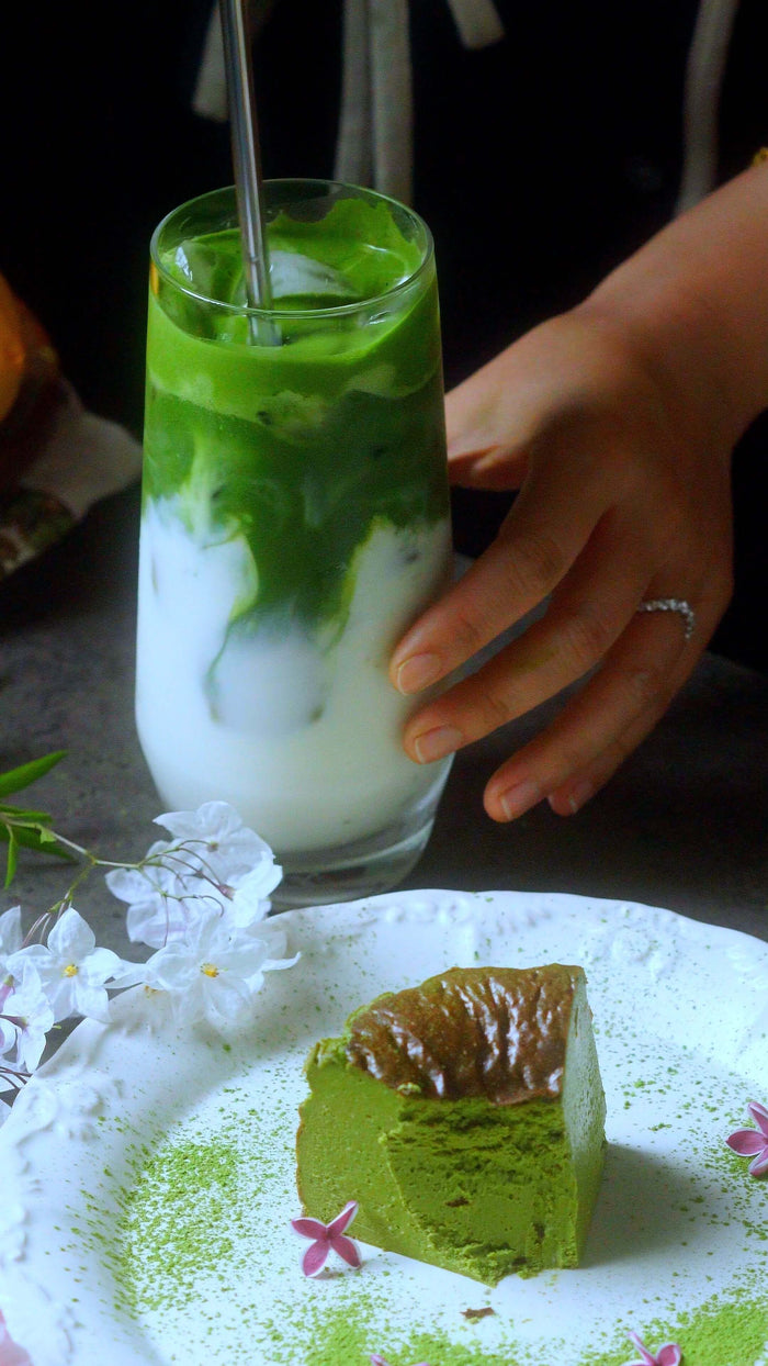 A creamy 30-second matcha latte recipe served with a slice of matcha cake on a decorative plate