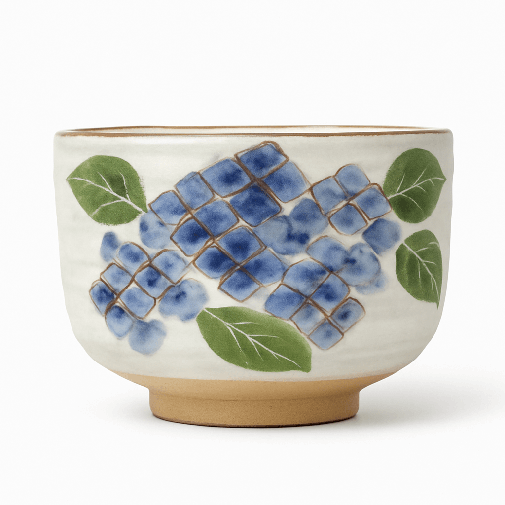 Handcrafted matcha bowl Kyoto featuring blue floral design and green leaves for traditional tea ceremonies