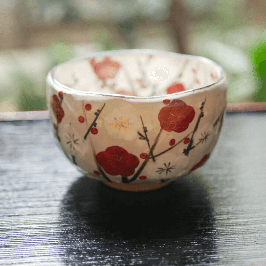 Decorative Japanese matcha bowl with floral design in red and yellow for tea ceremonies